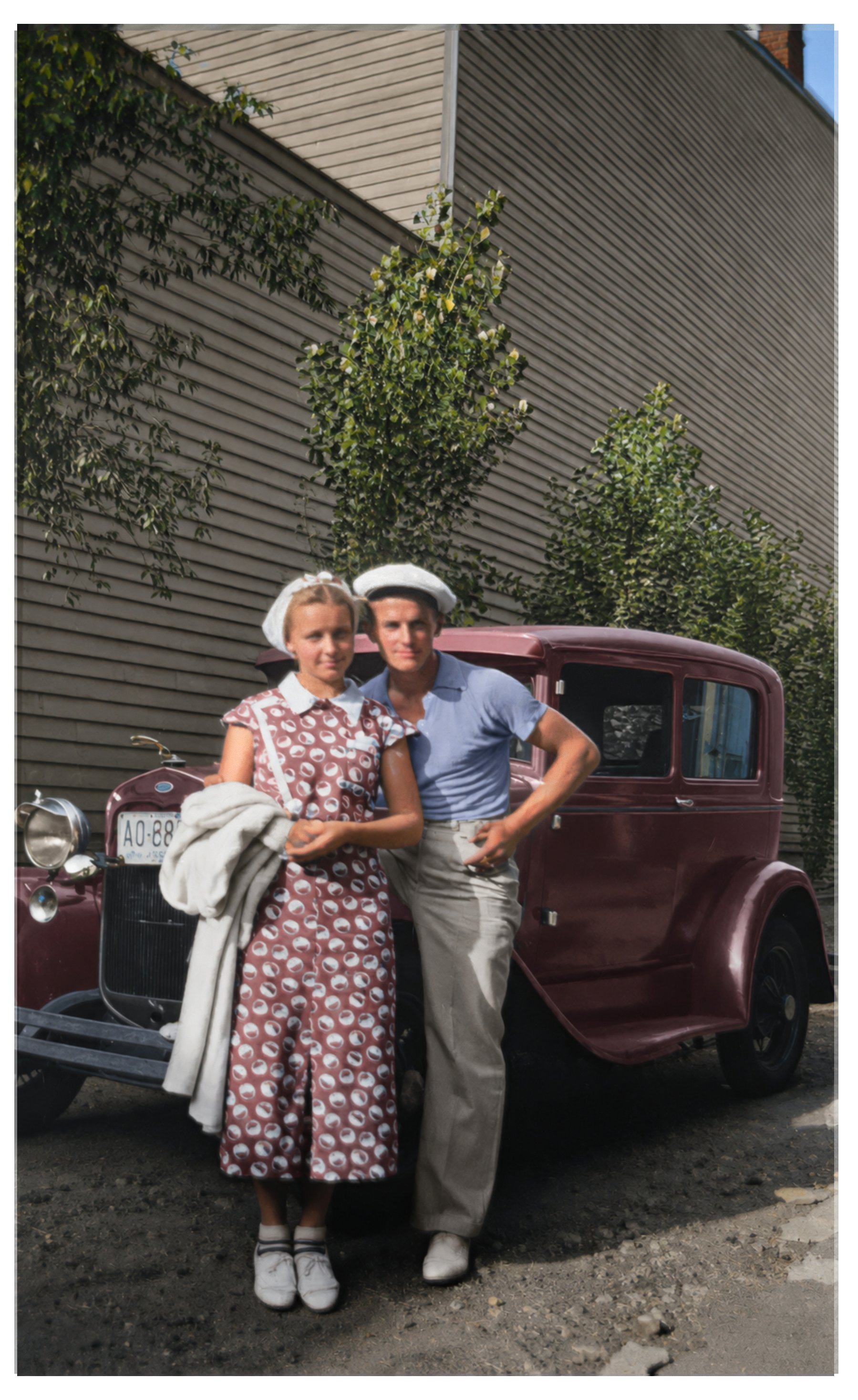 Colorized young couple by their sedan